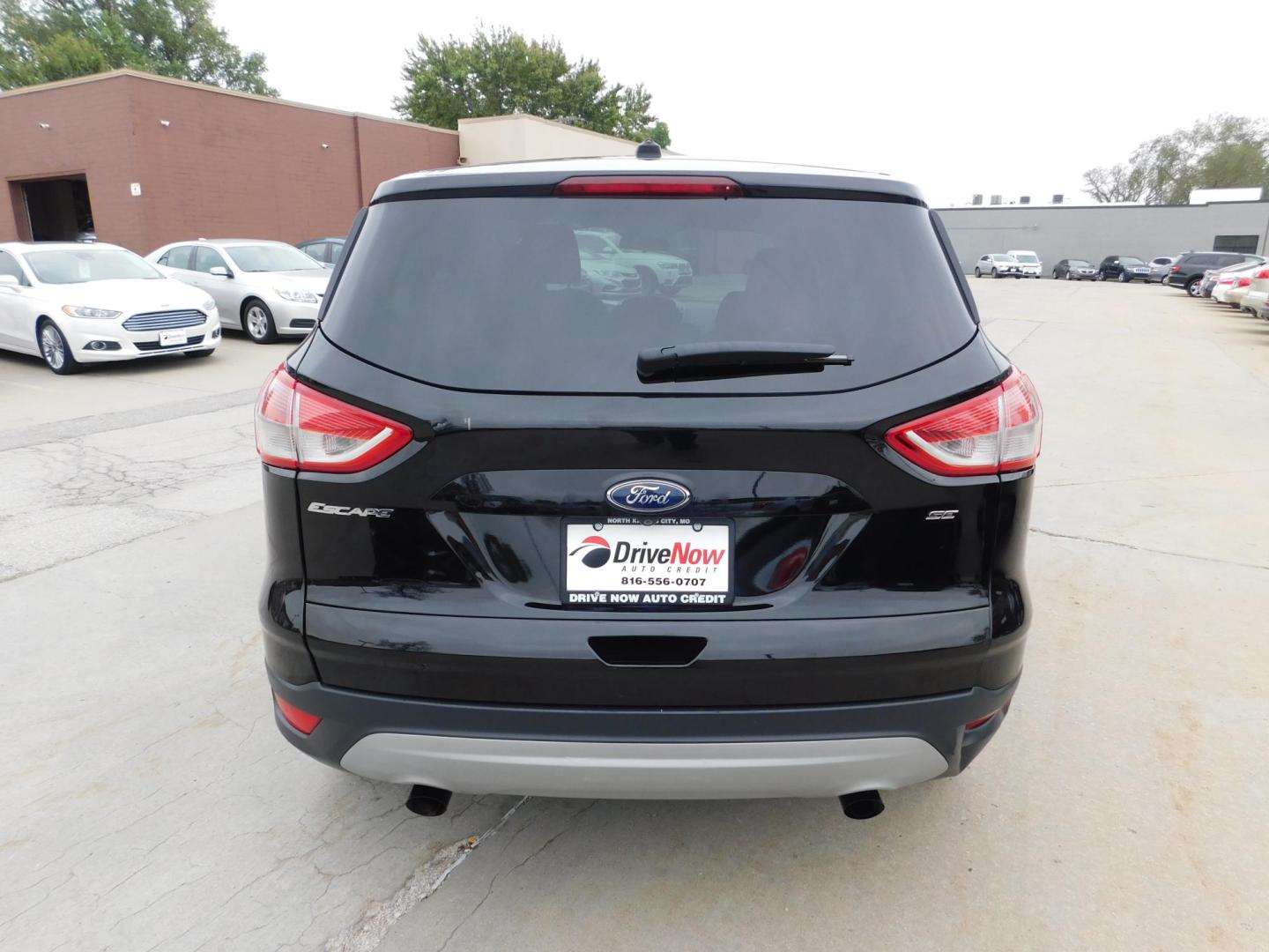 2016 BLACK Ford Escape SE FWD (1FMCU0G77GU) with an 2.5L L4 DOHC 16V engine, 6-Speed Automatic transmission, located at 2121 Burlington St, North Kansas City, MO, 64116, (816) 556-0707, 39.144707, -94.581978 - Photo#8