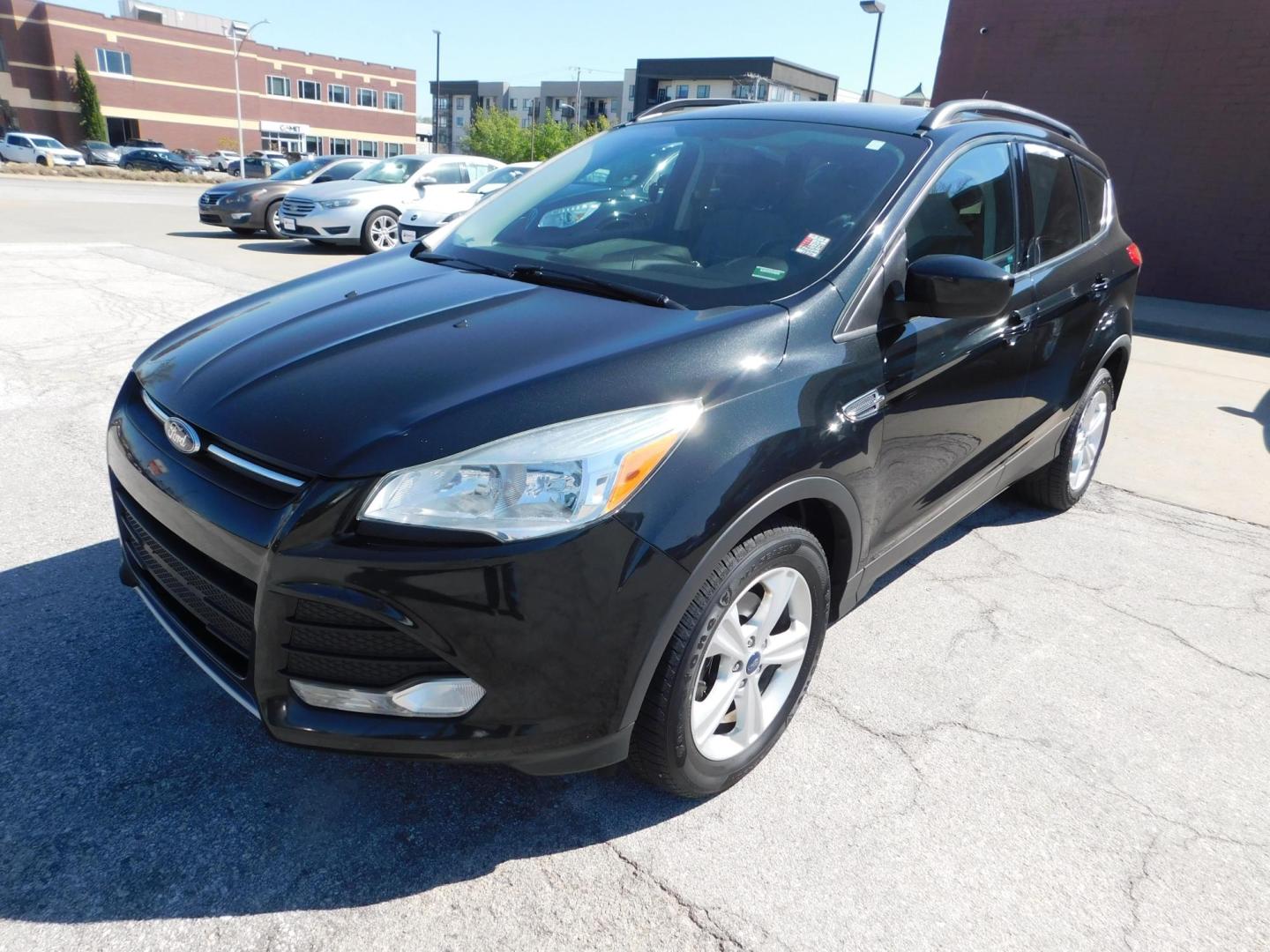 2014 BLACK Ford Escape SE FWD (1FMCU0GX4EU) with an 1.6L L4 DOHC 16V engine, 6-Speed Automatic transmission, located at 2121 Burlington St, North Kansas City, MO, 64116, (816) 556-0707, 39.144707, -94.581978 - Photo#0